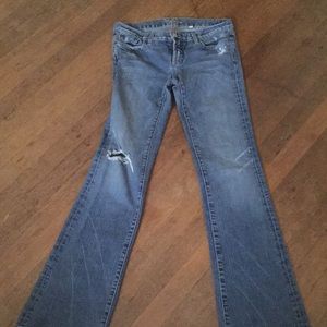 A pair of Bebe blue jeans